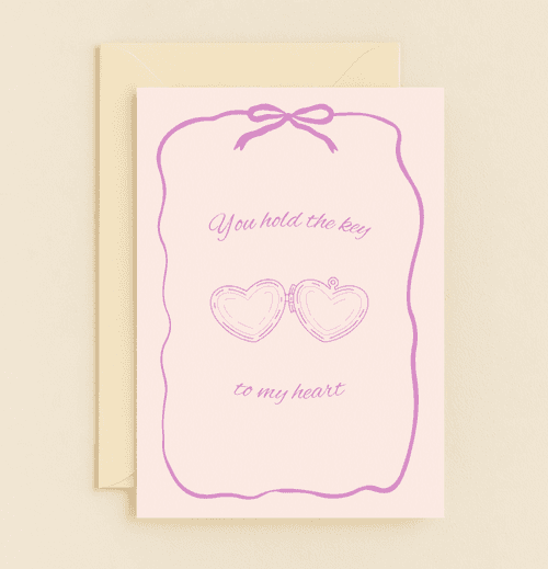 Celebrate love this Valentine's Day with a romantic pastel card featuring a heart-shaped locket and ribbon, perfect for expressing deep affection.